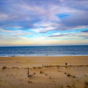 Scenic view of Rehoboth Beach coastline with golden sand and azure waters, a popular LGBTQ+ friendly destination for travelers.