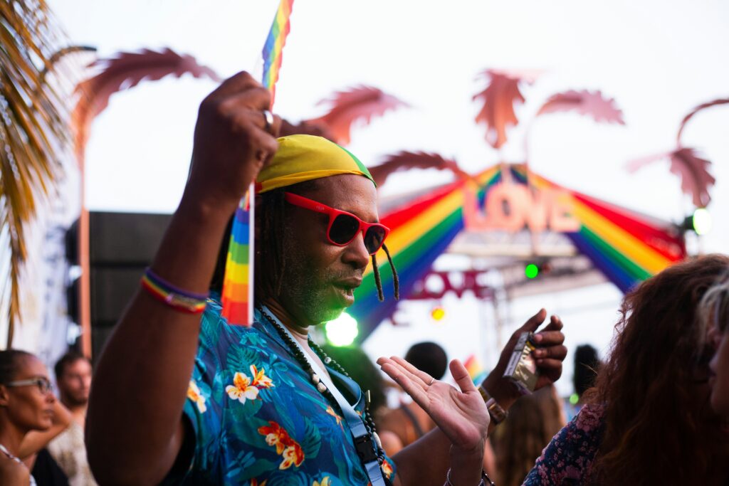 Gay man enjoying a gay pride celebration, showcasing Pride season celebration tips for a joyful and inclusive experience.