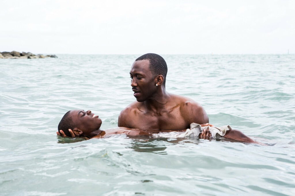 Two men in the water in Miami from the movie Moonlight, one of the best LGBTQ+ travel destination movies