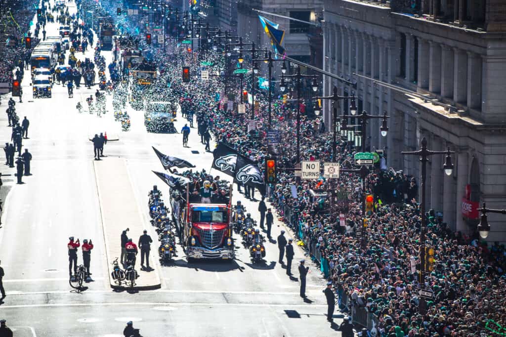 An aerial view of the Eagles Super Bowl Parade, showcasing thousands of supporters flooding the streets of Philadelphia.