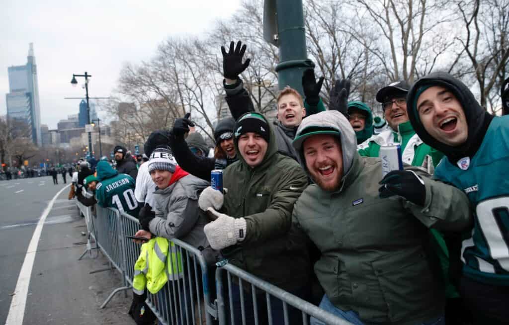 A rowdy group of Eagles fans chanting and cheering at the Eagles Super Bowl Parade.